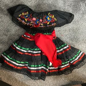 Traditional Mexican dress for a baby girl.